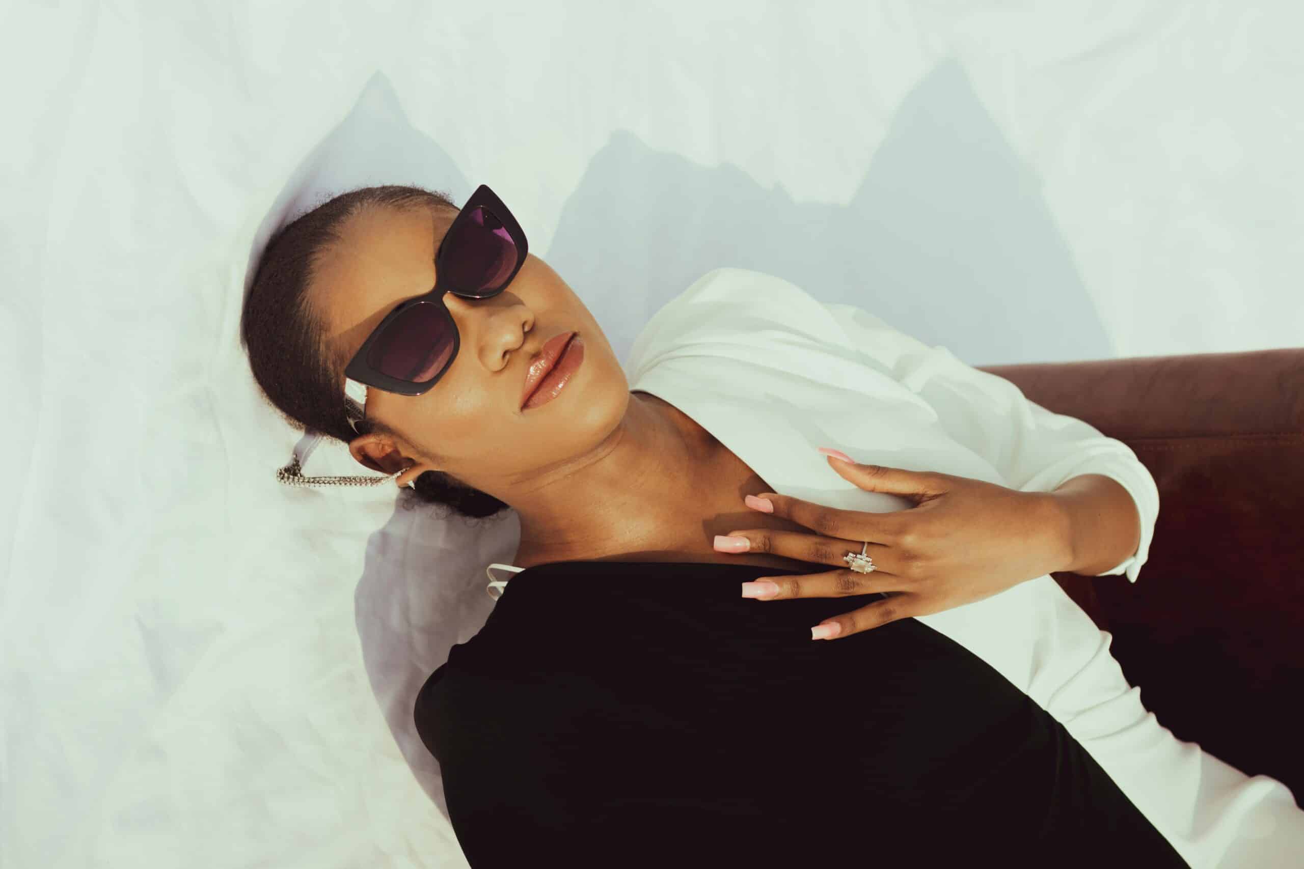 Woman wearing glasses laying down